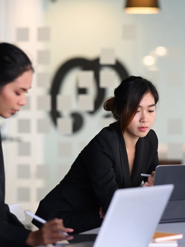 businesswoman-in-suit-experts-discussing-information-during-accounting-process-in-office-.jpg